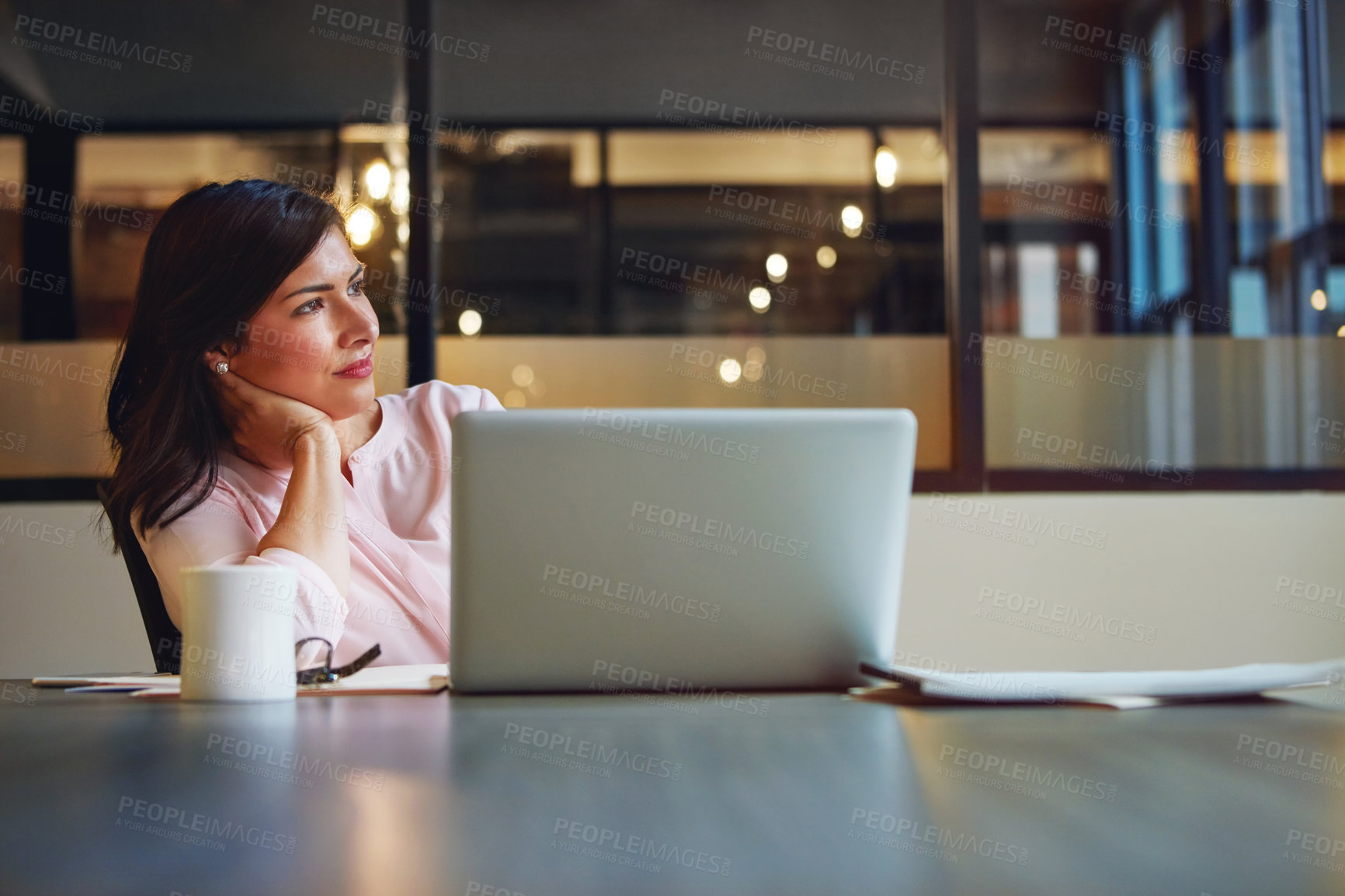 Buy stock photo Shot of a businesswoman daydreaming while working on a laptop in an office