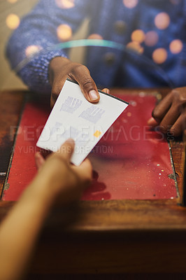 Buy stock photo Shot of an unrecognizable person receiving tickets from a vendor