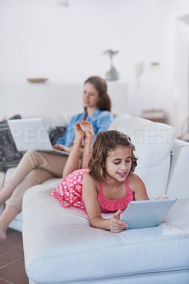 Buy stock photo Mother, child and tablet or laptop in home for online streaming for entertainment, movie or internet. Woman, daughter and connectivity on sofa or relax together in living room, games or subscription