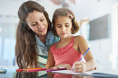 Buy stock photo Cropped shot of a mother watching her daughter colour in a picture