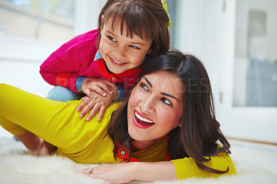 Buy stock photo Shot of an adorable little girl and her mother bonding at home