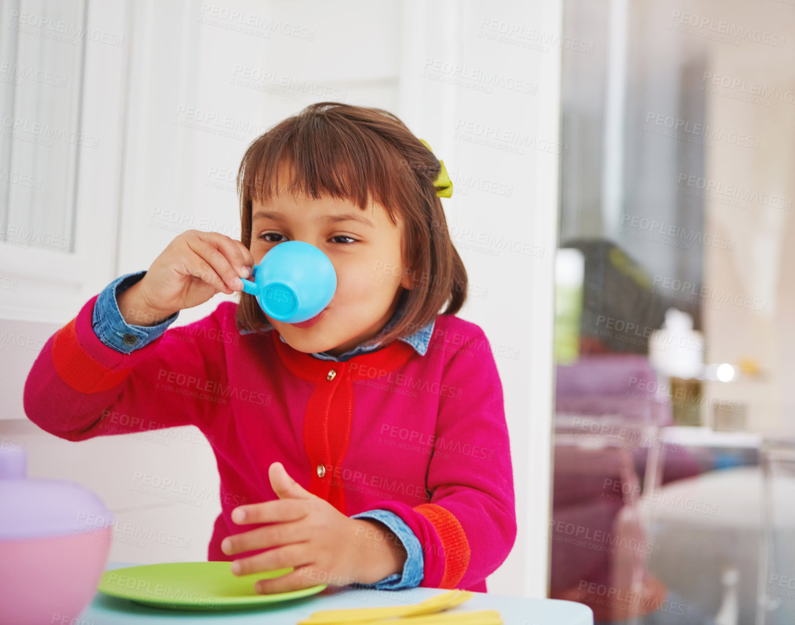 Buy stock photo Shot of an adorable little girl having a tea party at home