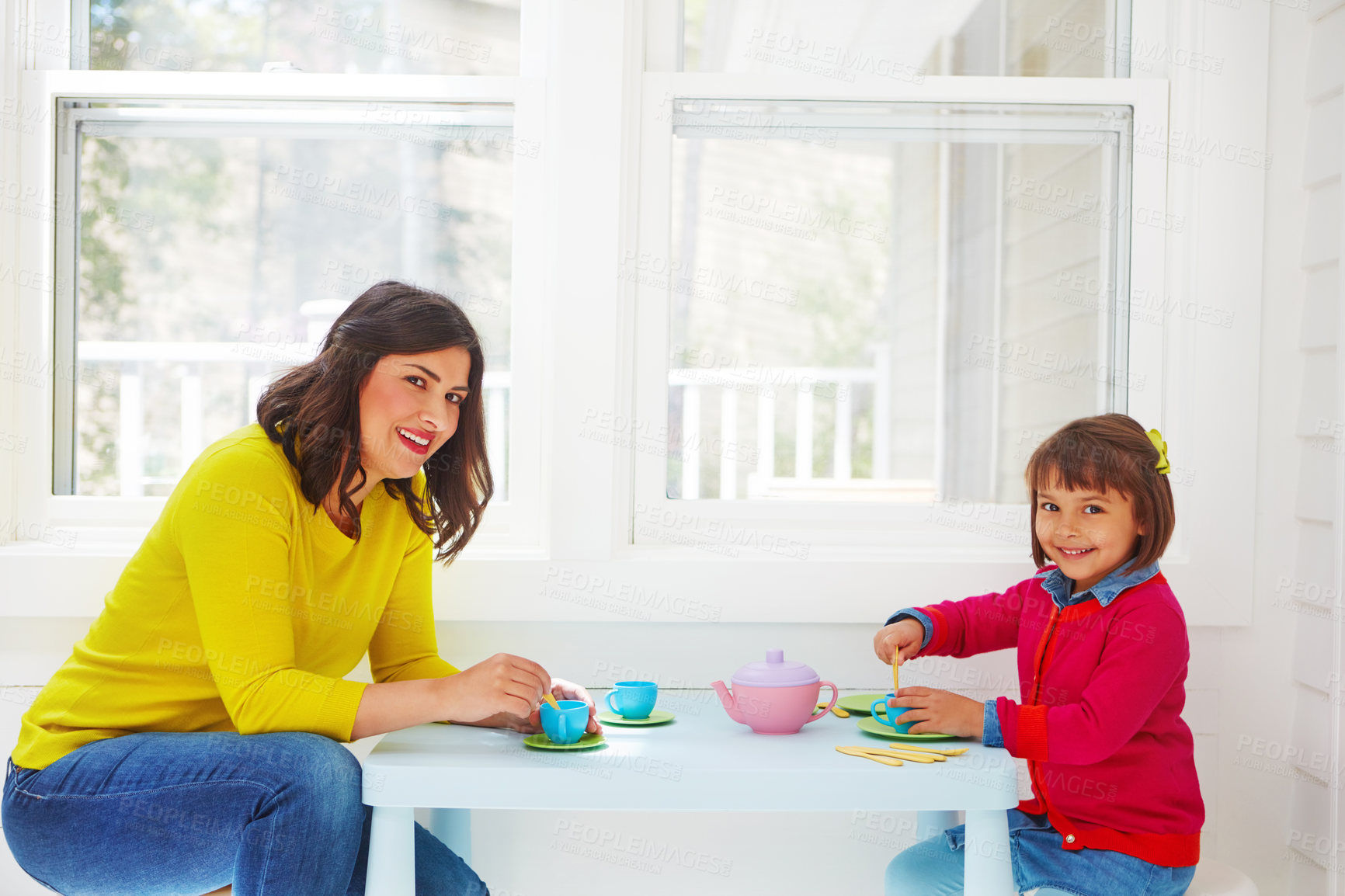 Buy stock photo Shot of an adorable little girl having a tea party with her mother at home