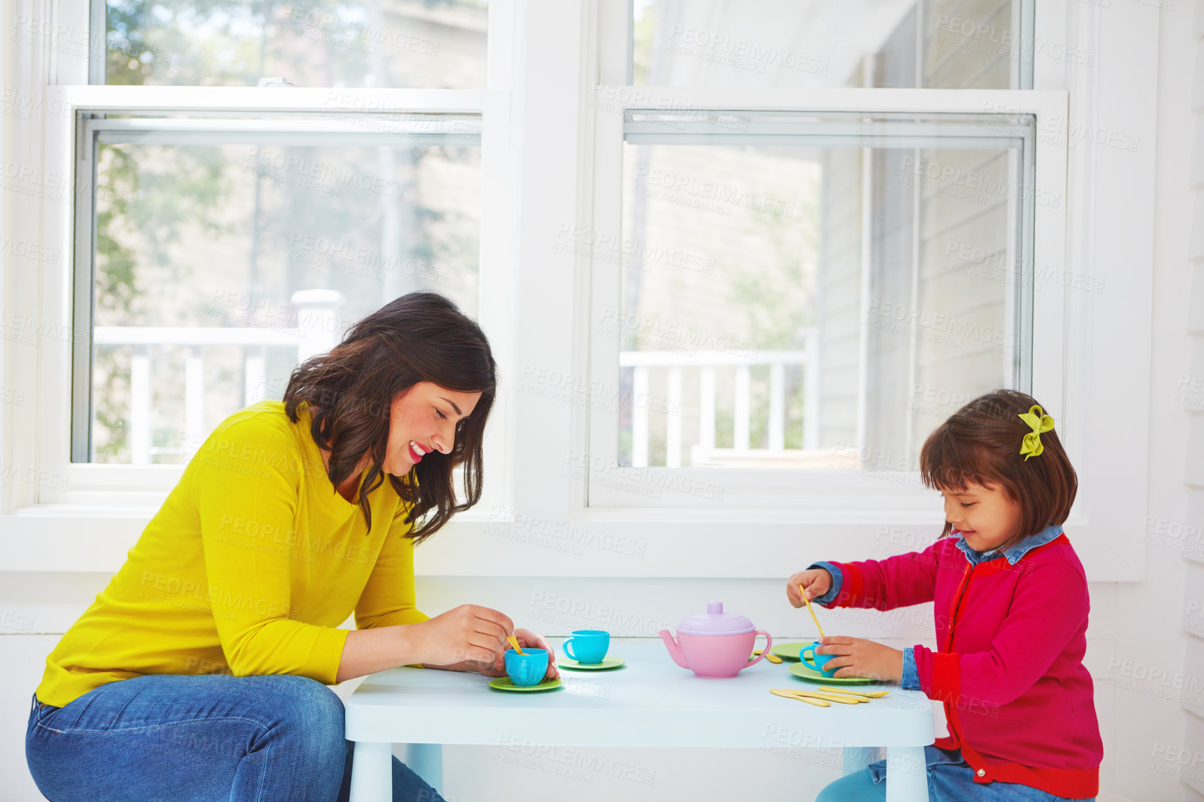 Buy stock photo Shot of an adorable little girl having a tea party with her mother at home