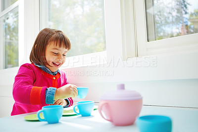 Buy stock photo Shot of an adorable little girl having a tea party at home