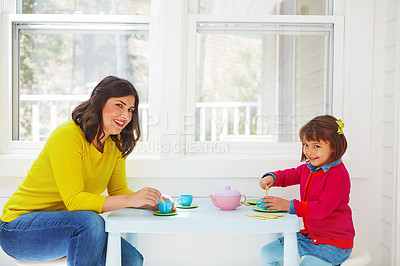 Buy stock photo Shot of an adorable little girl having a tea party with her mother at home