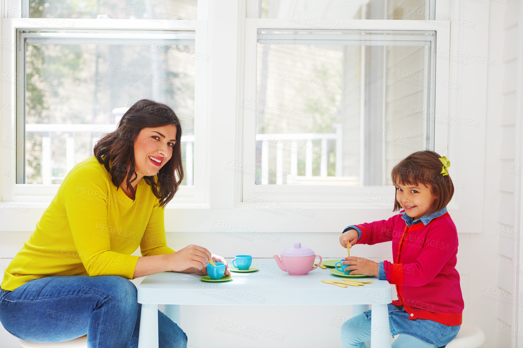 Buy stock photo Shot of an adorable little girl having a tea party with her mother at home