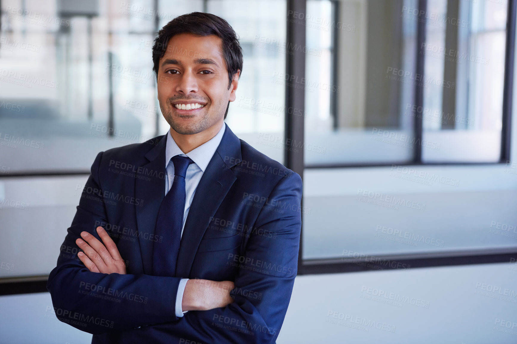 Buy stock photo Cropped portrait of a businessman standing with his arms folded in his office