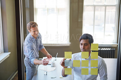 Buy stock photo Cropped shot of two businessmen preparing for a presentation by using adhesive notes