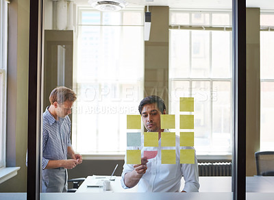 Buy stock photo Cropped shot of two businessmen preparing for a presentation by using adhesive notes