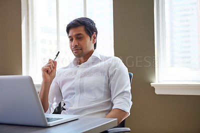 Buy stock photo Cropped shot of a businessman working at his desk