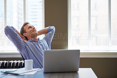 Buy stock photo Shot of a happy businessman leaning back in his chair