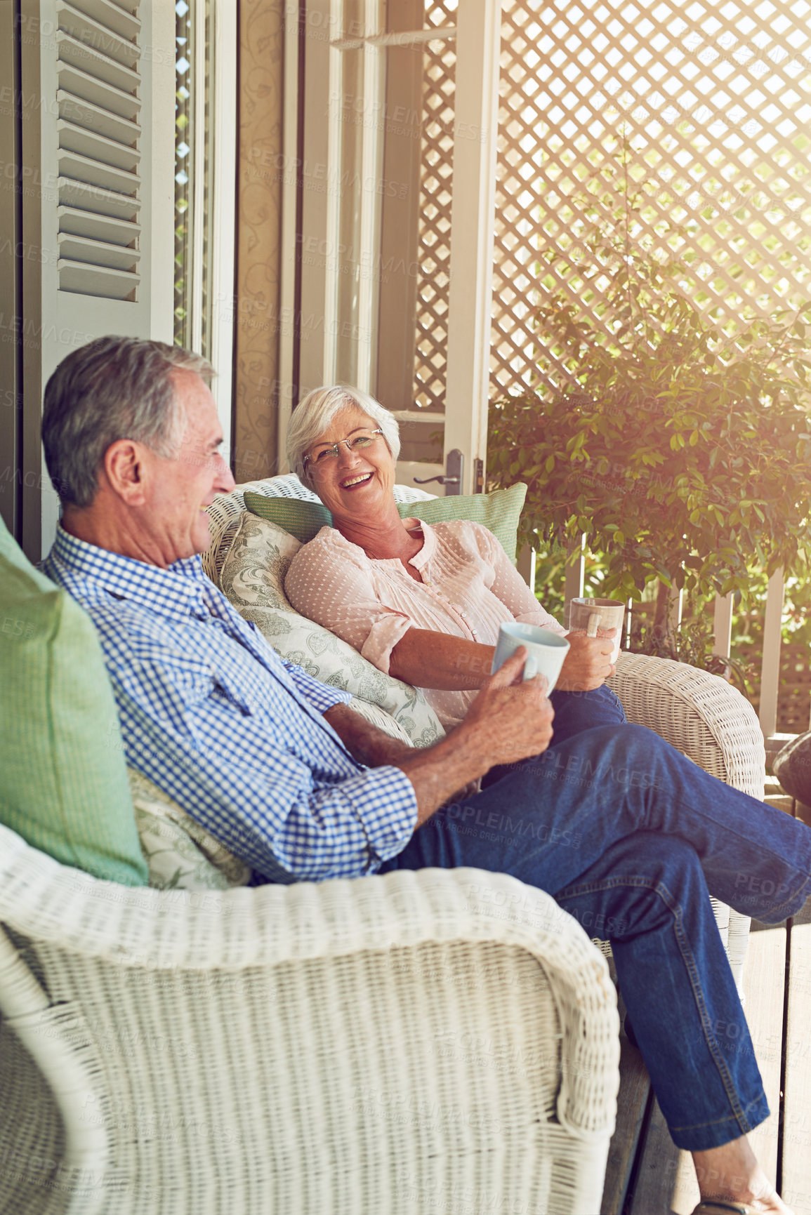 Buy stock photo Senior couple, coffee or relax on patio with love, bonding or happy memories at home. Marriage, elderly people or tea time on porch with retirement comfort, funny story or relationship care with joke