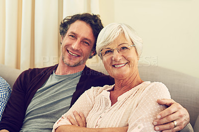 Buy stock photo Portrait of a man and his elderly  mother sitting together at home