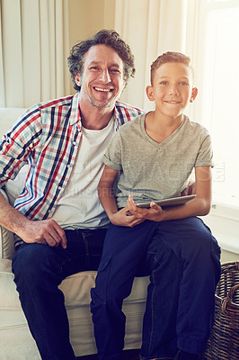 Buy stock photo Portrait of a boy sitting on his father's lap at home