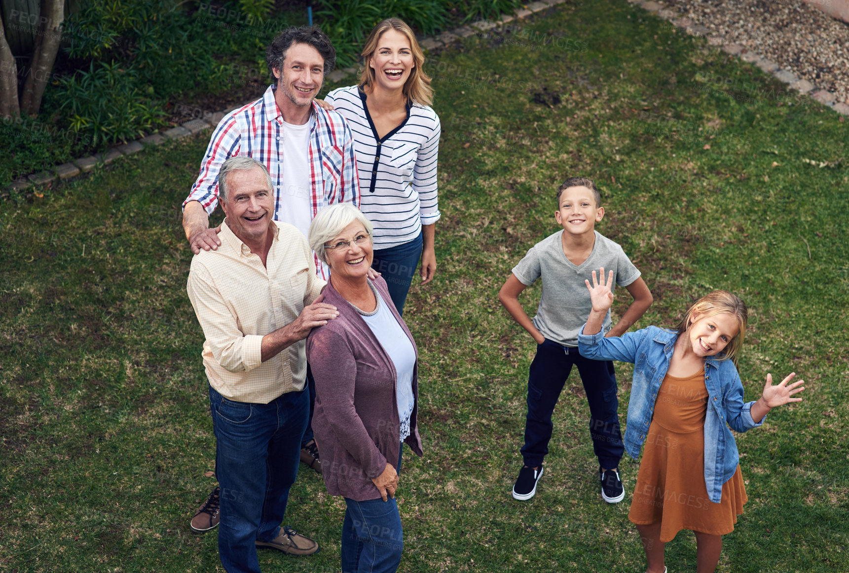 Buy stock photo High angle portrait of a family spending time together in their backyard