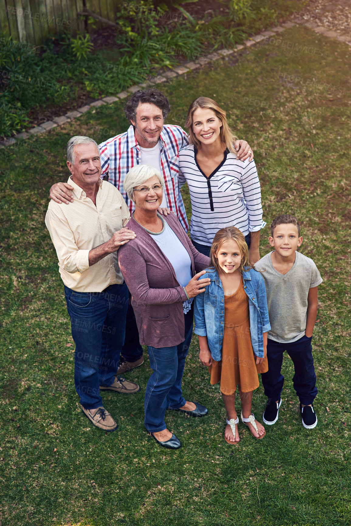 Buy stock photo High angle portrait of a family spending time together in their backyard