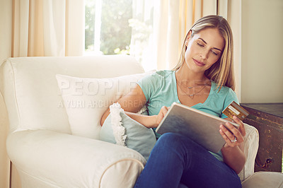 Buy stock photo Cropped shot of a woman doing online shopping on her tablet at home