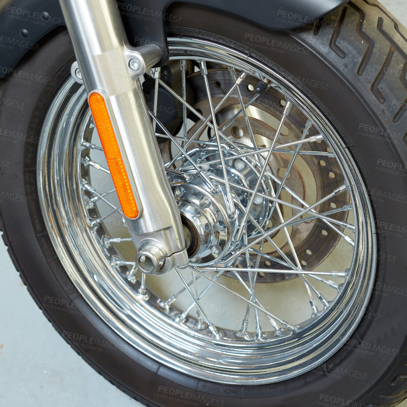 Buy stock photo Closeup of metal motorbike wheel spokes in mechanic garage. Clean, detailed, polished stainless steel motorcycle with black rubber tyre or tire, a shiny silver disk. Fixing rim or parts in repairshop