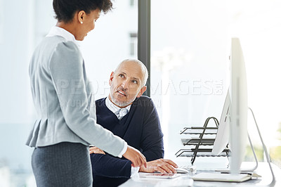 Buy stock photo Shot of two businesspeople using technology in the office