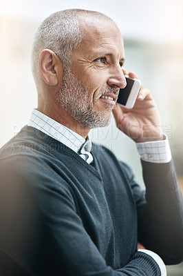 Buy stock photo Shot of a mature businessman taking a call at the office