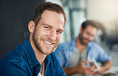 Buy stock photo Portrait of a young businessman sitting in a modern office with colleagues