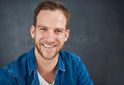 Buy stock photo Cropped shot of a young businessman sitting against a grey background