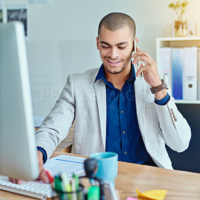 Buy stock photo Cropped shot of a young businessman talking on a cellphone in an office