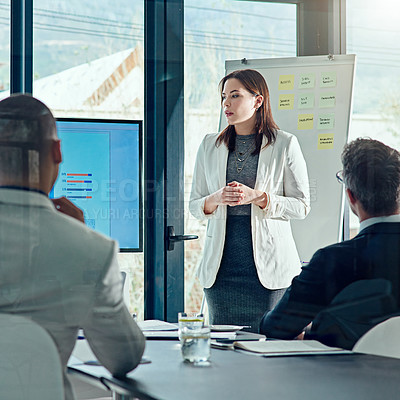 Buy stock photo Cropped shot of a businesswoman delivering a presentation in the boardroom