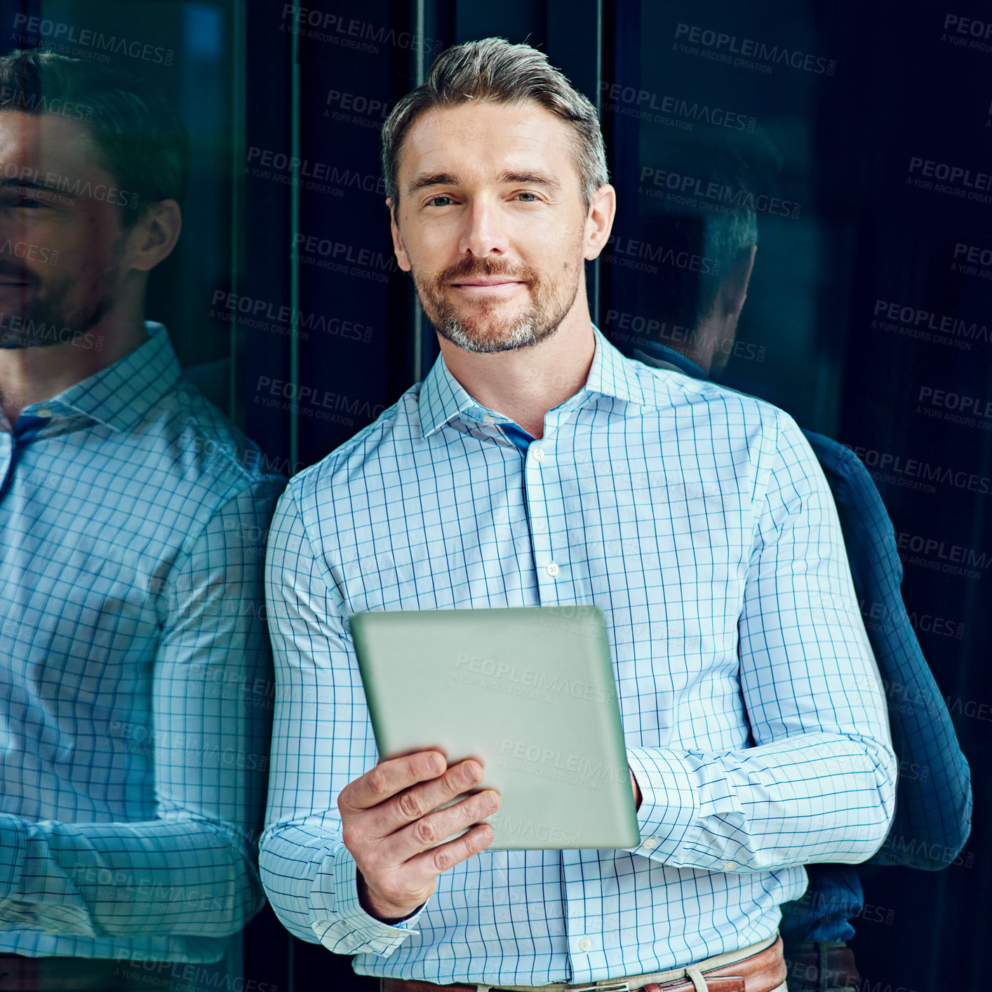 Buy stock photo Portrait of a businessman using a digital tablet at work