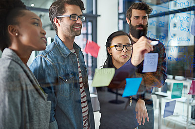 Buy stock photo Cropped shot of coworkers brainstorming in a modern office