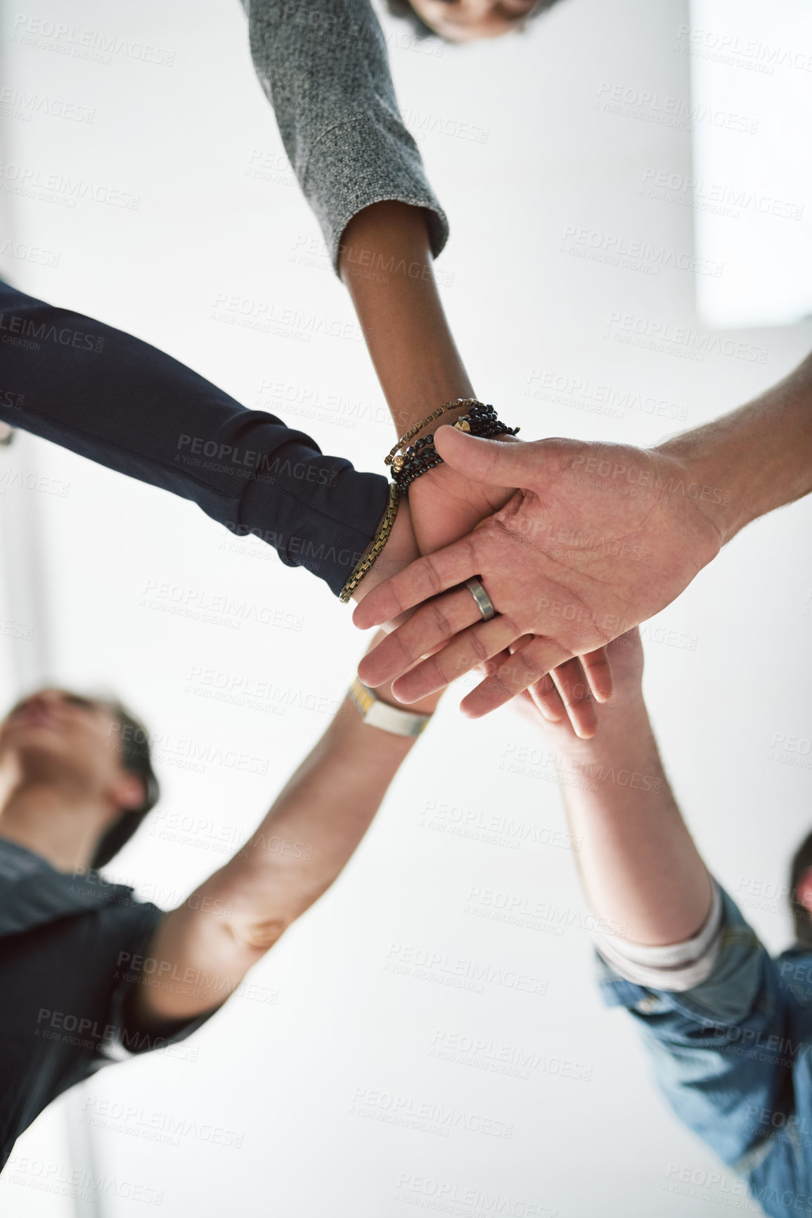 Buy stock photo Cropped shot of a group of people stacking their hands on top of each other