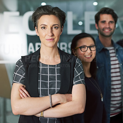 Buy stock photo Cropped portrait of a creative businesswoman standing with her colleagues behind her