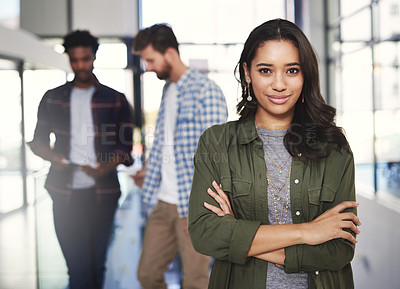 Buy stock photo Portrait of a young designer standing in a modern office with colleagues in the background