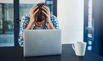Buy stock photo Cropped shot of a stressed out young designer sitting with a laptop in a modern office