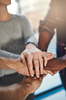Buy stock photo Closeup shot of three colleagues joining their hands together in unity