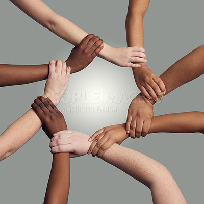 Buy stock photo Hands, wrist and together with circle in studio for synergy or collaboration with respect and diversity with harmony. Team, holding and connection in solidarity or alliance, trust and grey background