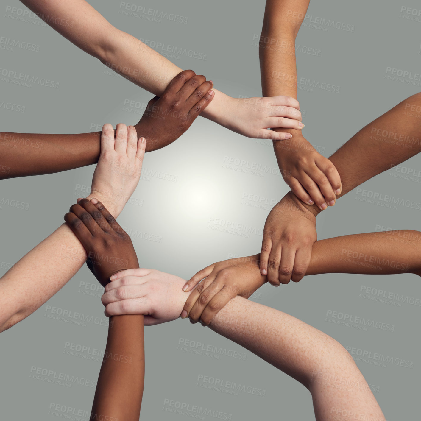Buy stock photo Cropped shot of a group of hands holding on to each other at the wrist against a grey background
