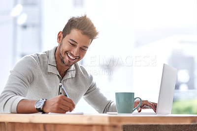 Buy stock photo Shot of a young entrepreneur speaking on his cellphone in his office