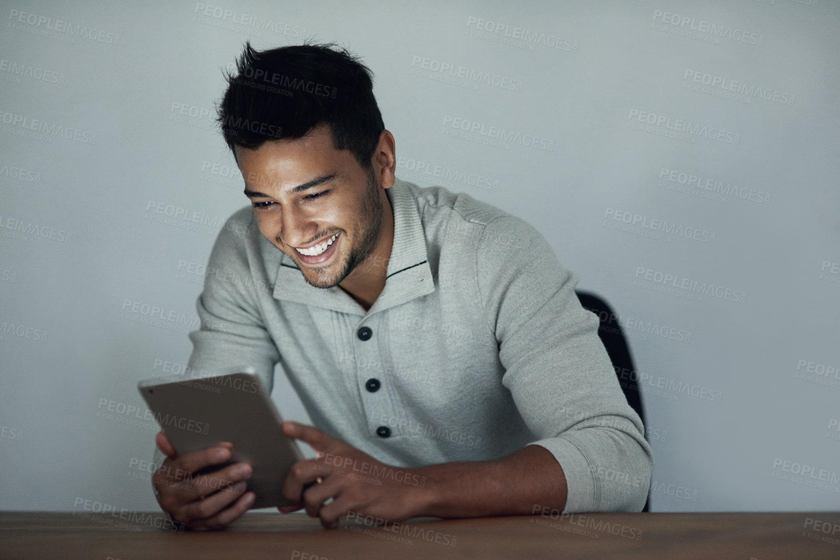 Buy stock photo Cropped shot of a young man using his tablet at night