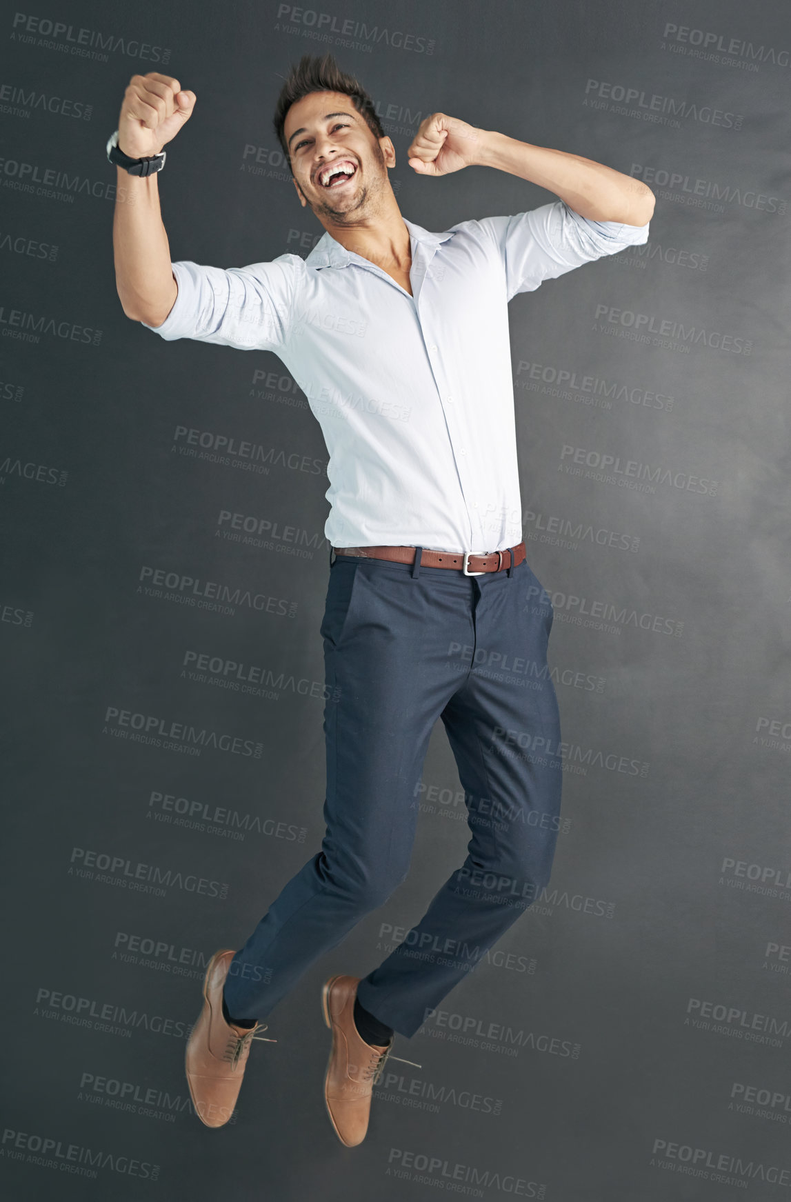 Buy stock photo Studio shot of a happy businessman jumping for joy