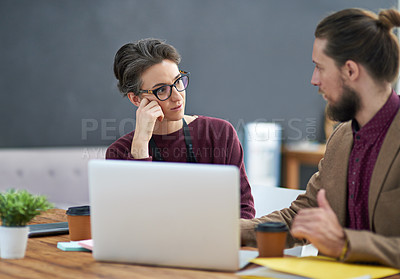 Buy stock photo Cropped shot of a bored businesswoman listening to her colleague explain something