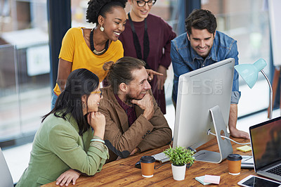 Buy stock photo Cropped shot of a group of creative businesspeople looking at something on a computer