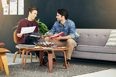 Buy stock photo Shot of young creatives having a discussion in a modern office