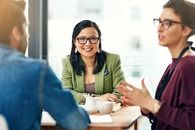 Buy stock photo Portrait of a young businesswoman sitting in a meeting with her colleagues