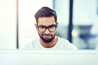 Buy stock photo Cropped shot of a young man working in his office