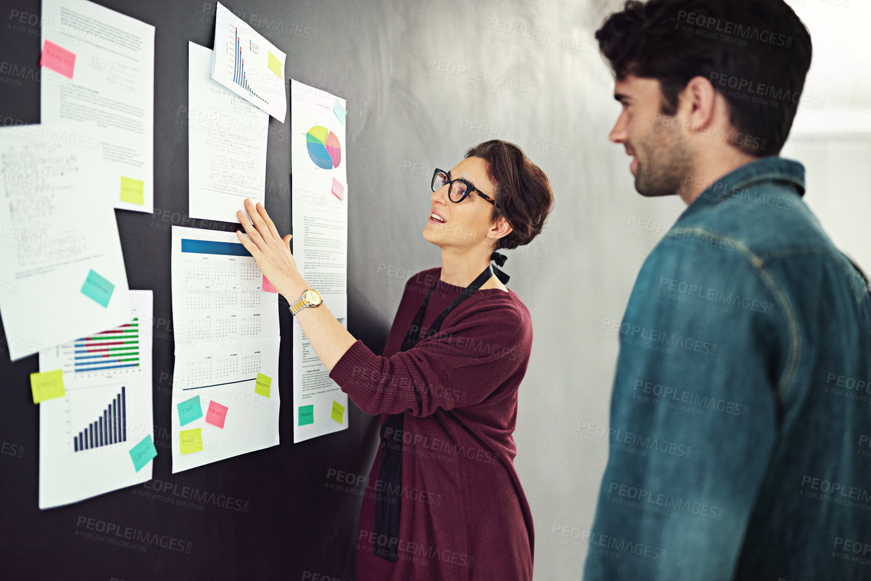 Buy stock photo Cropped shot of coworkers brainstorming in a modern office