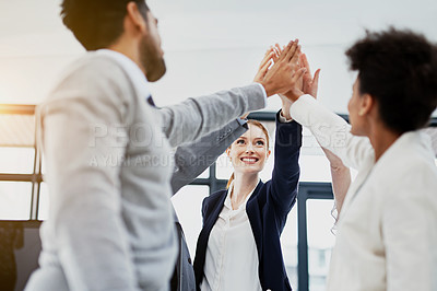 Buy stock photo Shot of a group of businesspeople high-fiving in the office