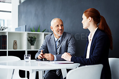 Buy stock photo Shot of two businesspeople working together on  project
