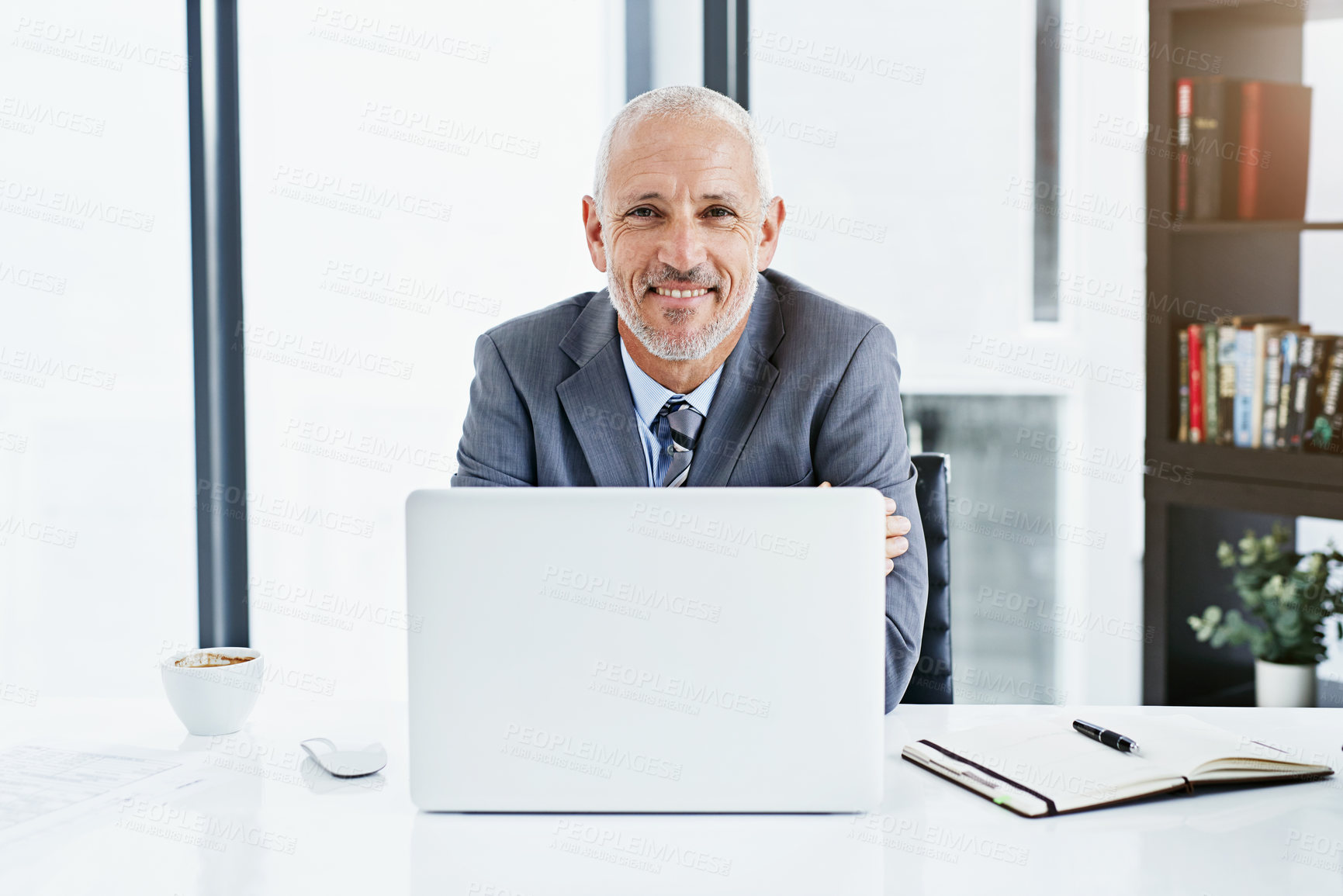 Buy stock photo Shot of a businessman working at his desk